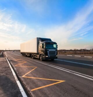 Full Truckload (FTL) vs. Less-than-Truckload (LTL): Which Shipping Option Is Right for You? 1 black-truck-moving-city-s-suburb